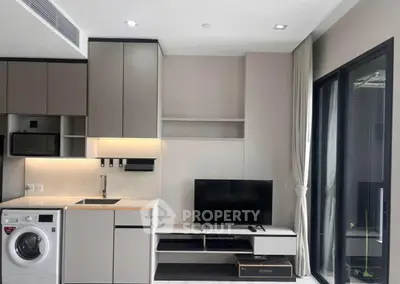 Modern living room with sleek kitchen appliances and stylish decor