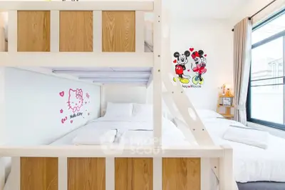 Charming bedroom with bunk beds and playful wall art, perfect for a cozy family stay.