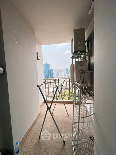High-rise apartment balcony with city view and laundry area