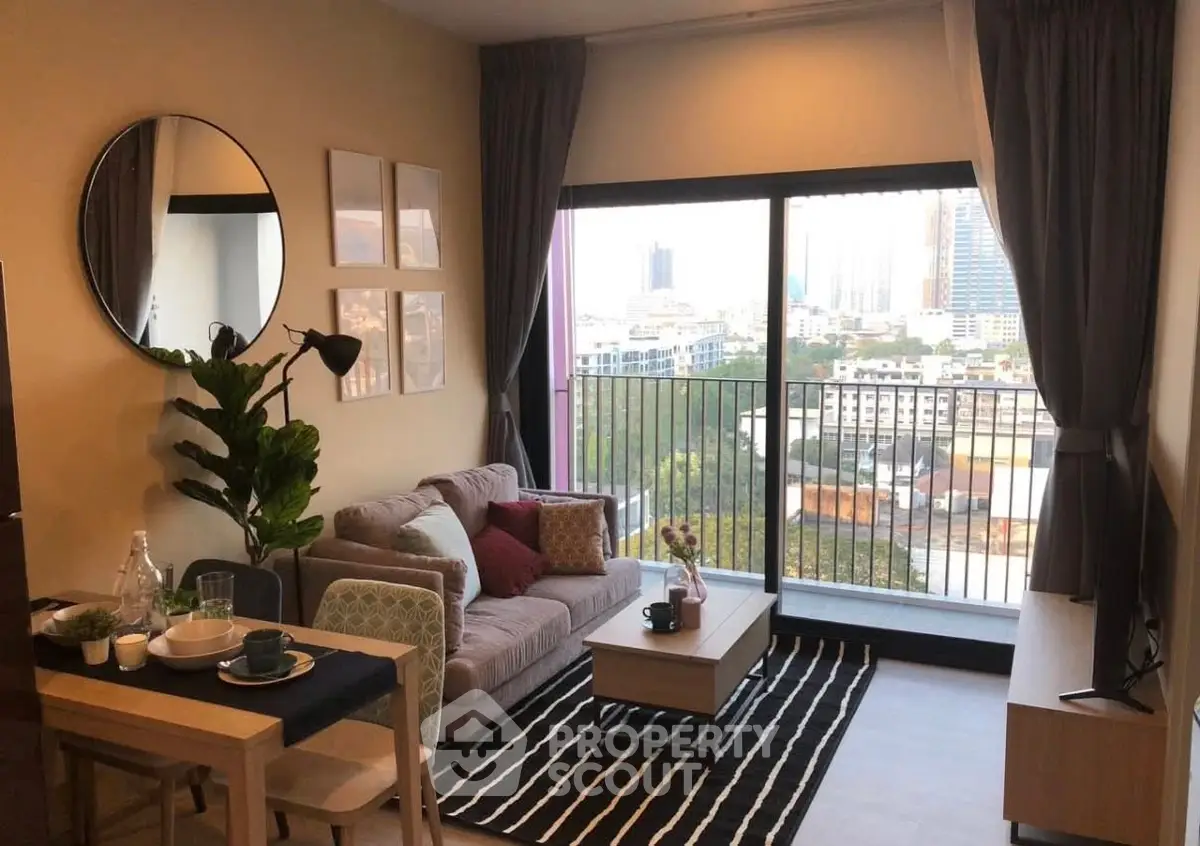 Modern living room with city view, stylish decor, and cozy seating area.