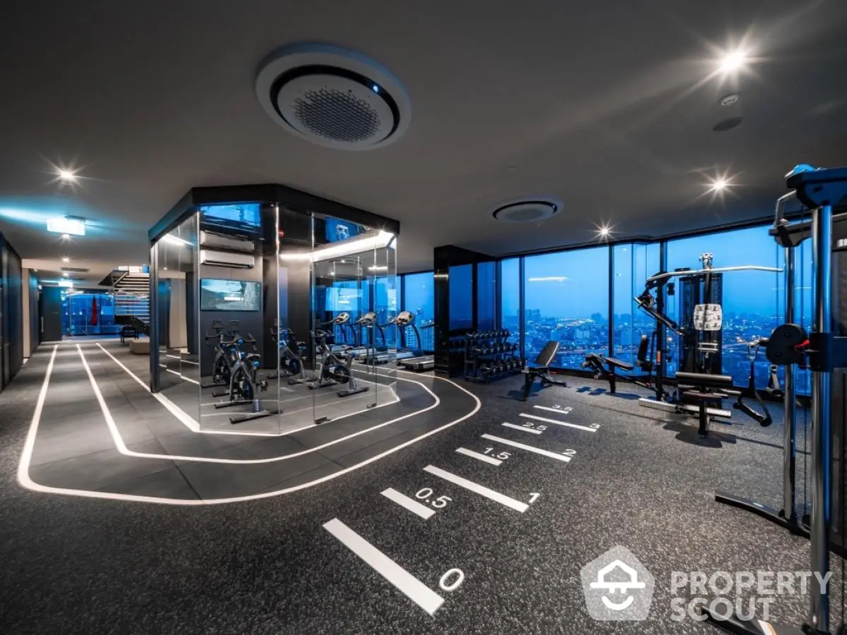 Luxurious high-rise gym with panoramic city views and modern fitness equipment.