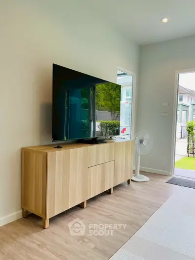 Modern living room with sleek TV setup and stylish wooden cabinet