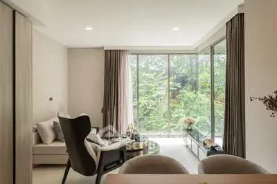 Modern living room with large windows and lush garden view, featuring stylish furniture and elegant decor.