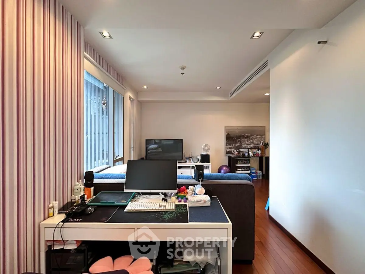 Spacious living room with modern decor and ample natural light