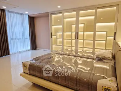 Luxurious bedroom with modern lighting and large windows in a stylish apartment.