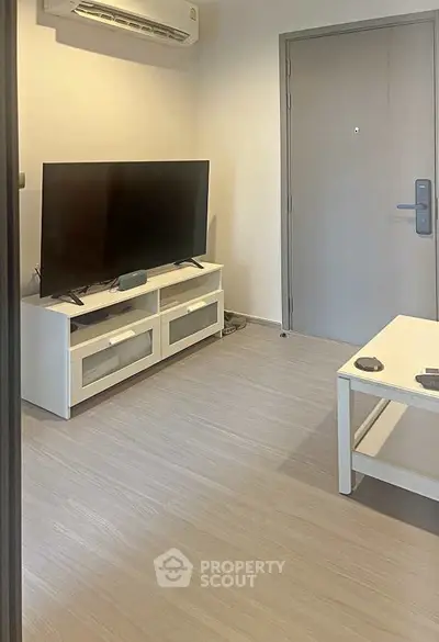 Modern living room with sleek TV setup and minimalist furniture design.