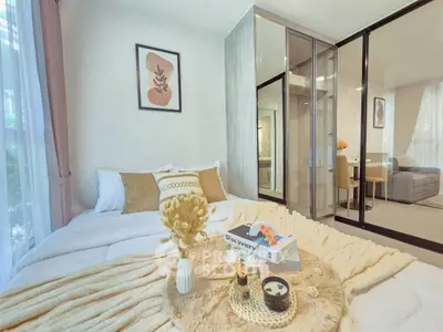 Cozy bedroom with elegant decor and glass partition leading to living area