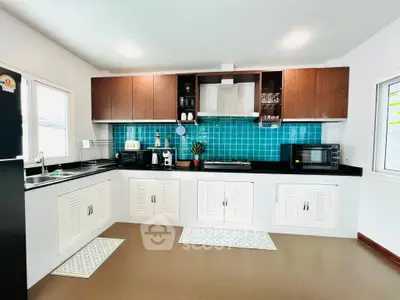 Modern kitchen with turquoise backsplash and sleek appliances