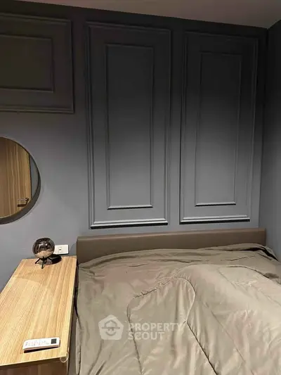 Modern bedroom with stylish panel wall and cozy bedding