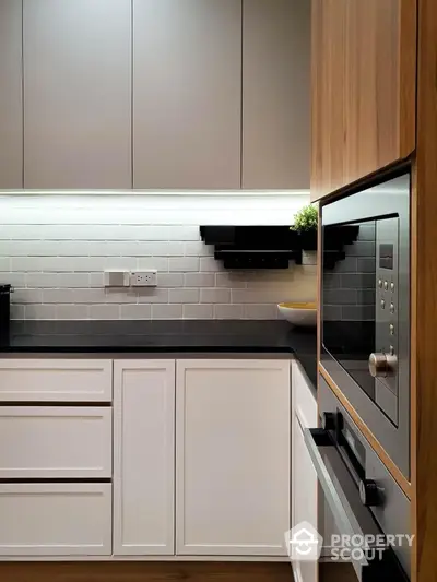 Modern kitchen with sleek cabinetry and built-in oven