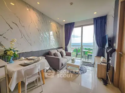 Modern living room with ocean view, stylish decor, and open layout in a luxury apartment.