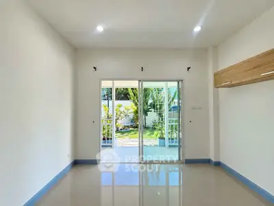 Spacious living room with garden view and sliding glass doors