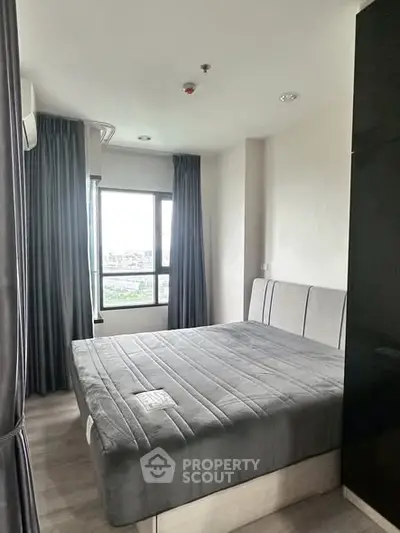 Modern bedroom with large window and stylish gray decor