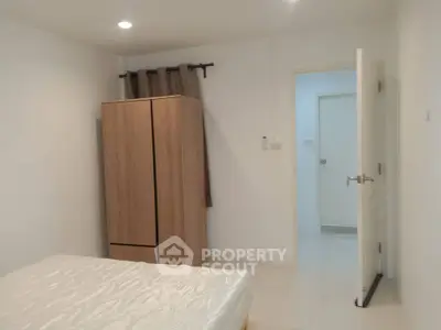Spacious bedroom with modern wardrobe and cozy ambiance
