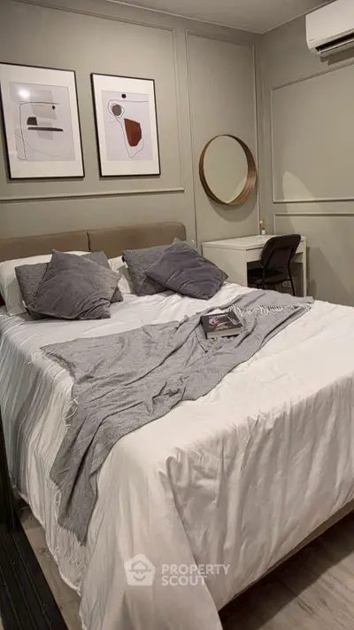 Cozy bedroom with modern decor and stylish wall art, featuring a comfortable bed and elegant furnishings.