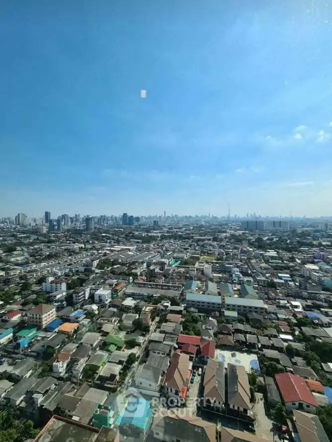 Breathtaking panoramic cityscape view from high-rise building, showcasing urban skyline under clear blue sky.