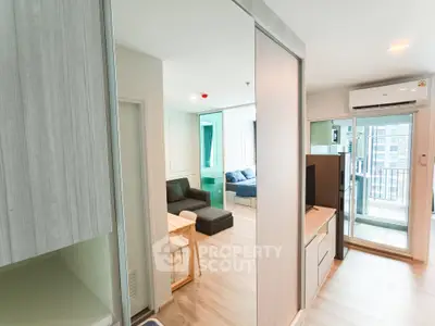 Modern open-layout apartment with sleek design and balcony access, featuring stylish living area and ample natural light.