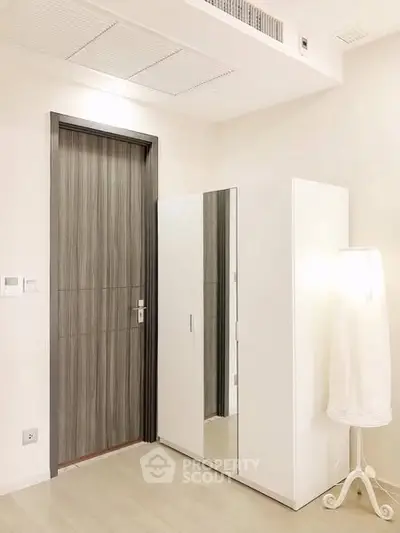 Modern minimalist bedroom with sleek wardrobe and stylish lighting