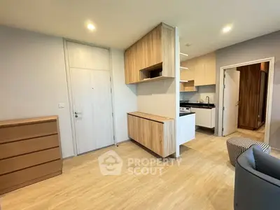 Modern open-plan living room with sleek kitchen and wooden flooring