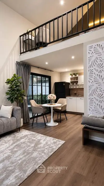 Modern open-plan living room with loft, stylish decor, and natural light.