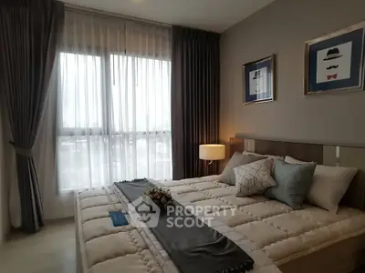Cozy modern bedroom with elegant decor and large window