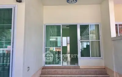 Charming entrance with sliding glass doors leading to a cozy interior space, perfect for welcoming guests.