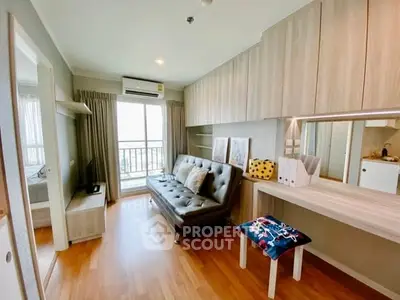 Modern living room with balcony view, stylish decor, and open layout in a cozy apartment.