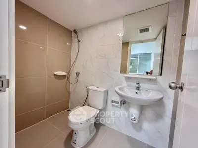 Modern bathroom with sleek fixtures and neutral tiles