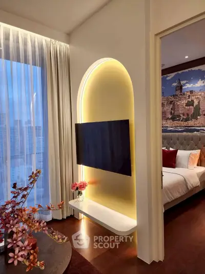 Luxurious modern living room with stylish TV setup and elegant bedroom view, perfect for urban living.