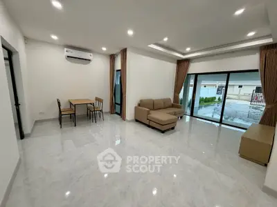 Spacious modern living room with large windows and elegant furniture