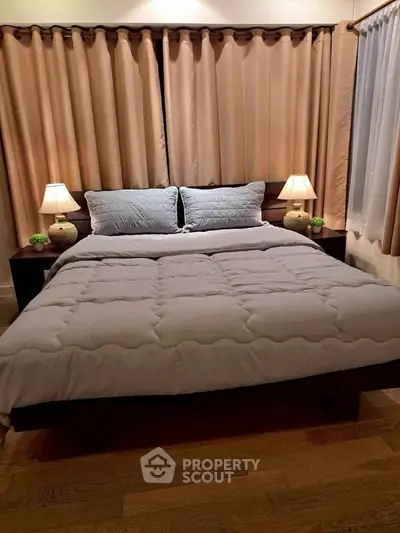 Cozy bedroom with elegant lighting and plush bedding for ultimate relaxation.
