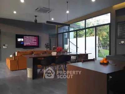 Spacious modern living room with open layout and garden view, perfect for entertaining.