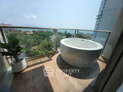 Luxurious balcony with freestanding bathtub and stunning panoramic view.