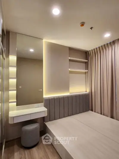 Modern bedroom with built-in lighting and sleek design, featuring a cozy bed and stylish decor.