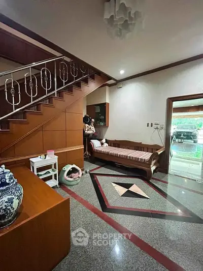 Spacious interior with elegant staircase and cozy seating area