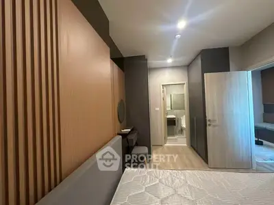 Modern bedroom with ensuite bathroom and stylish wood paneling