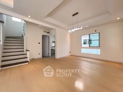 Spacious modern living room with wooden flooring and stylish lighting