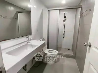 Modern bathroom with sleek fixtures and spacious shower area in a contemporary home.