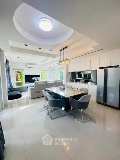 Modern open-plan kitchen and living room with sleek design and natural light