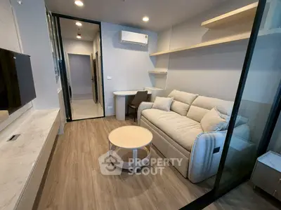 Modern living room with cozy sofa and stylish decor in a contemporary apartment.