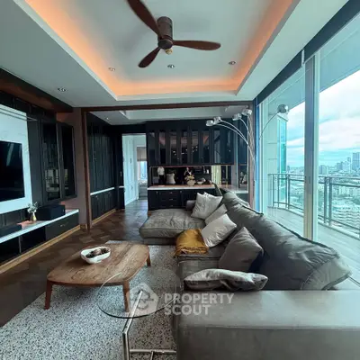 Luxurious living room with panoramic city views and modern furnishings in a high-rise apartment.