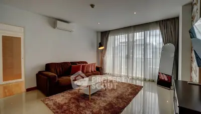 Spacious living room with modern decor and large windows for natural light.