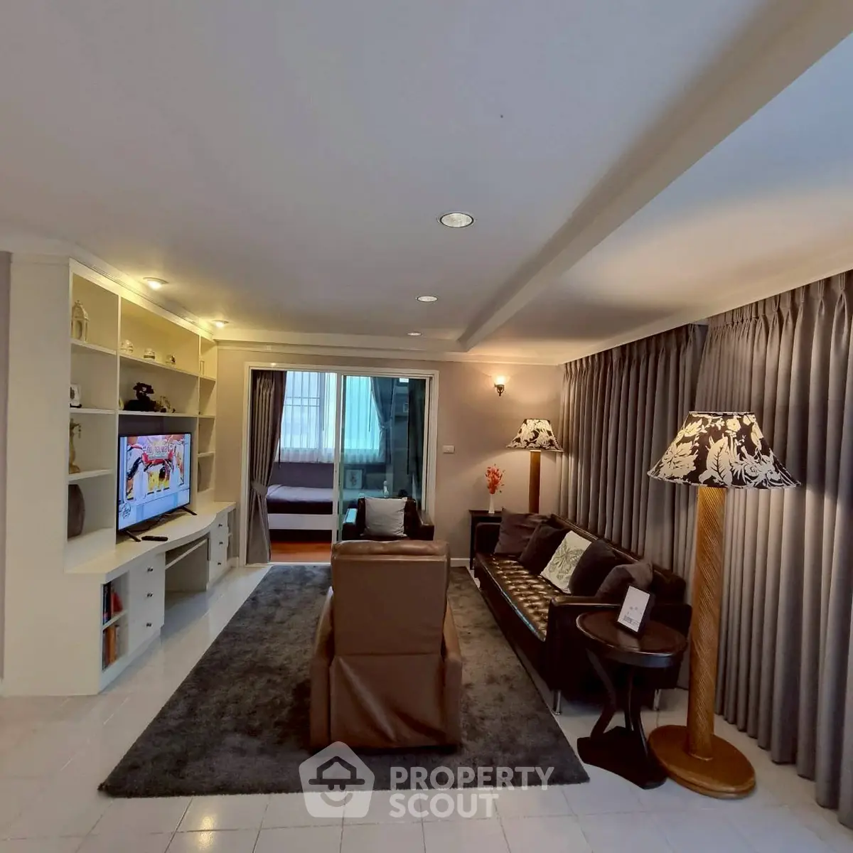 Spacious living room with elegant decor and cozy seating area, perfect for relaxation and entertainment.