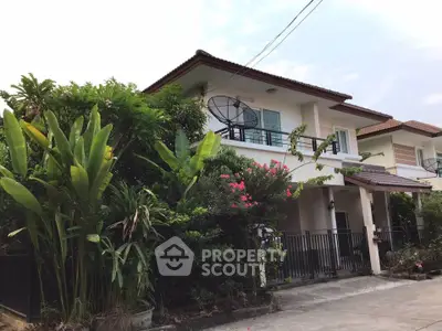 Charming two-story house with lush garden and balcony in serene neighborhood.
