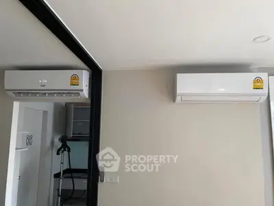 Modern apartment interior with dual air conditioning units for optimal climate control.