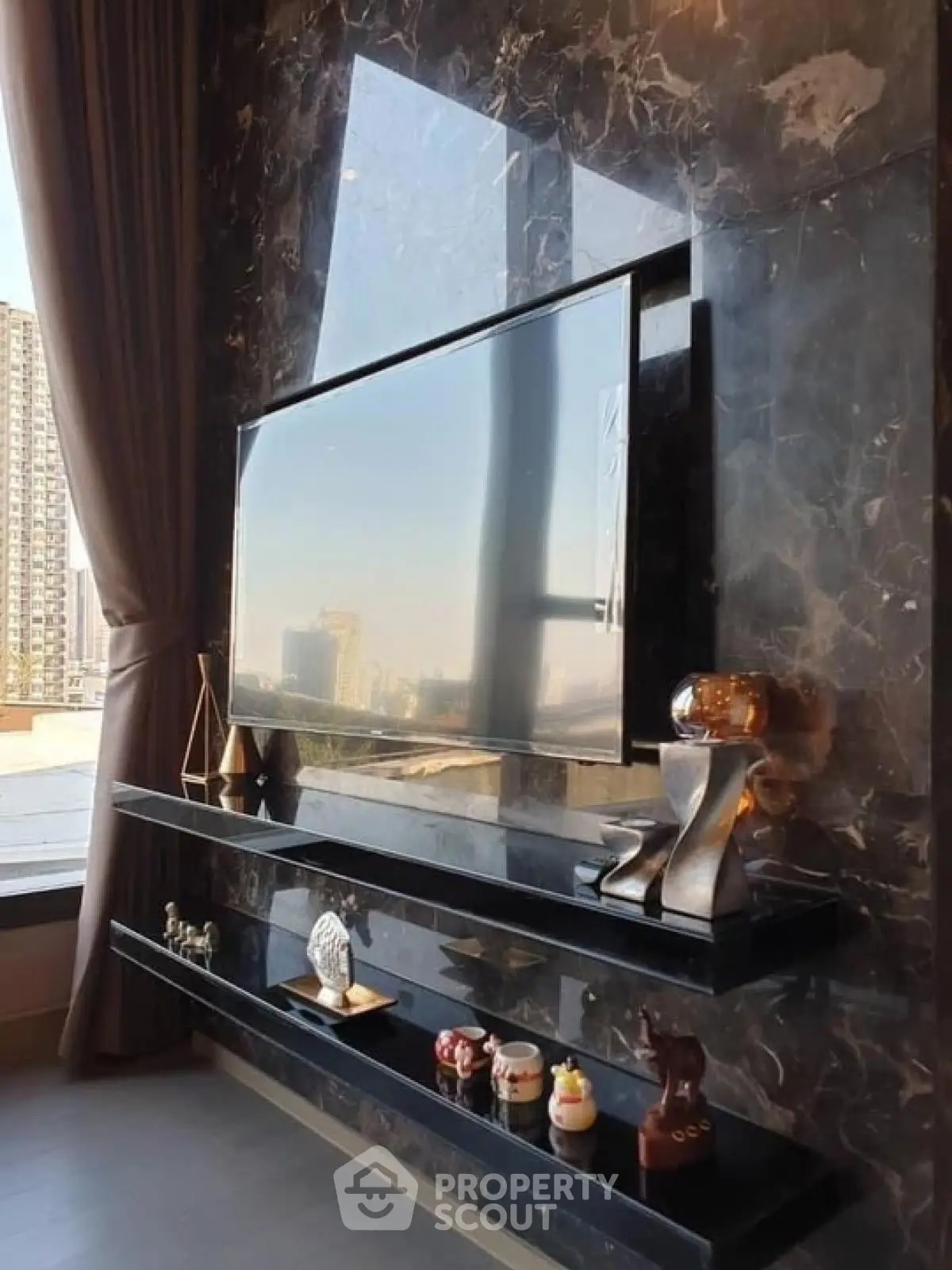 Luxurious living room with marble wall and large TV, city view window