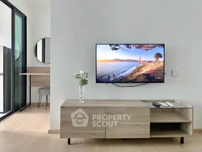 Modern living room with wall-mounted TV and stylish wooden furniture