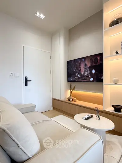 Modern living room with sleek design, cozy sofa, and wall-mounted TV for ultimate comfort and style.