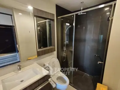 Modern bathroom with glass shower and sleek fixtures