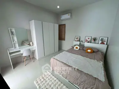 Modern bedroom with stylish decor, featuring a cozy bed, sleek wardrobe, and elegant vanity desk.